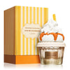 Perfume bottle with whipped cream and a box labeled 'Give Me Gourmand' by Lattafa on a white background.